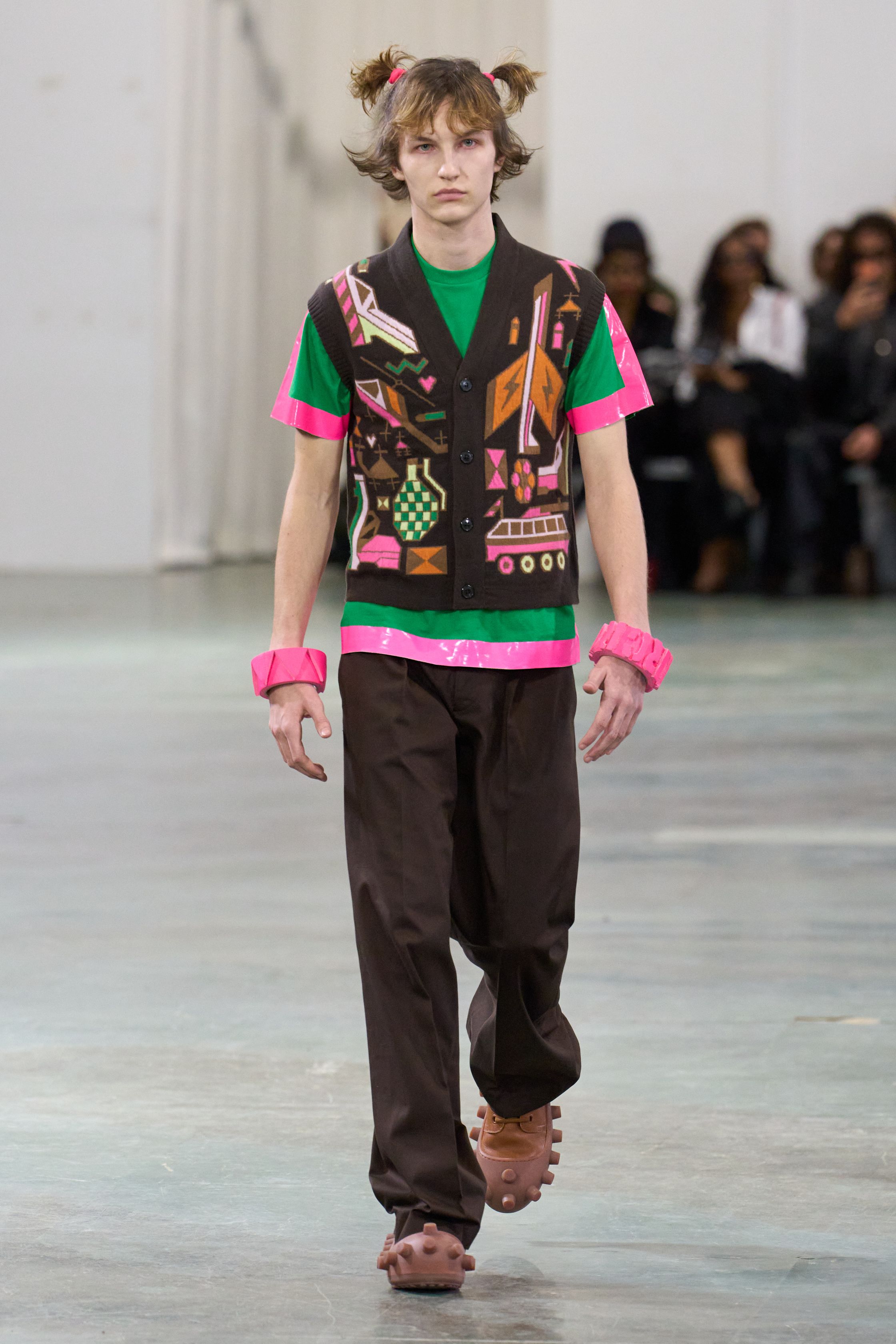 Walter Van Beirendonck 2026秋冬以高度饱和的色彩、夸张比例与童真符号继续挑战男性气质的既定边界。针织花朵、卡通图案、结构化西装与机能裤装并置，构建出介于游戏、政治隐喻与乌托邦幻想之间的舞台。系列拒绝低调，刻意制造视觉噪音，用快乐、怪诞与不合时宜的色彩作为对现实焦虑的反击，呈现一场毫不妥协的时装宣言-顽石频道趋势研究
